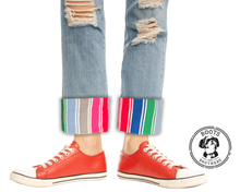 Load image into Gallery viewer, Red sneakers with colorful rolled-up jeans and rainbow striped good guys Chucky cosplay cuffs on a white background, featuring the Boots &amp; Brothers logo.